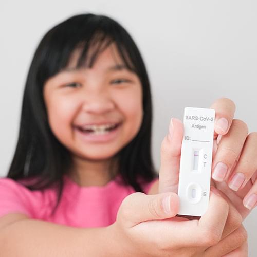 A smiling young girl holding