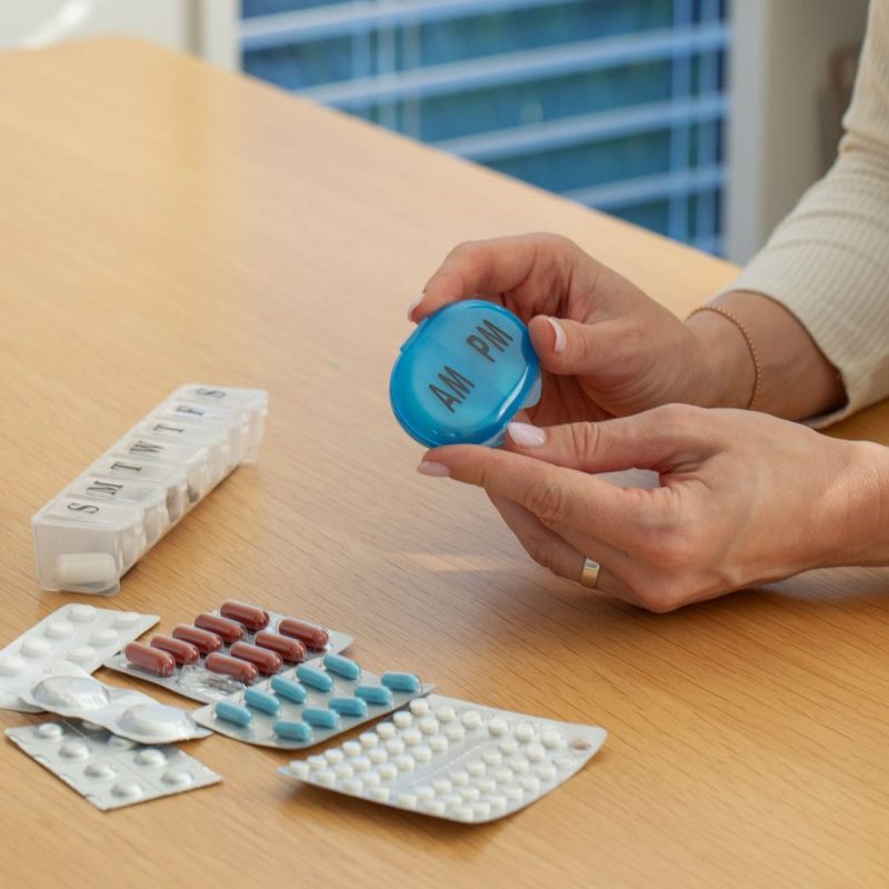 caucasian-woman-organizes-weekly-medication-