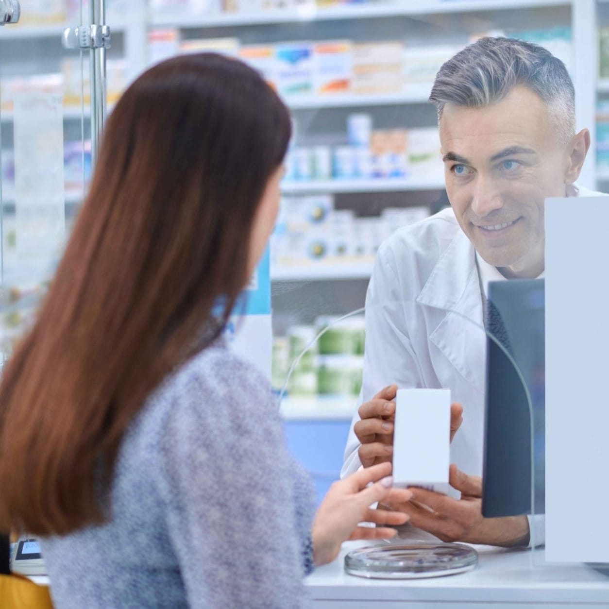 Pharmacist handing a prescription refill to a patient at Cloud Pharmacy Toronto